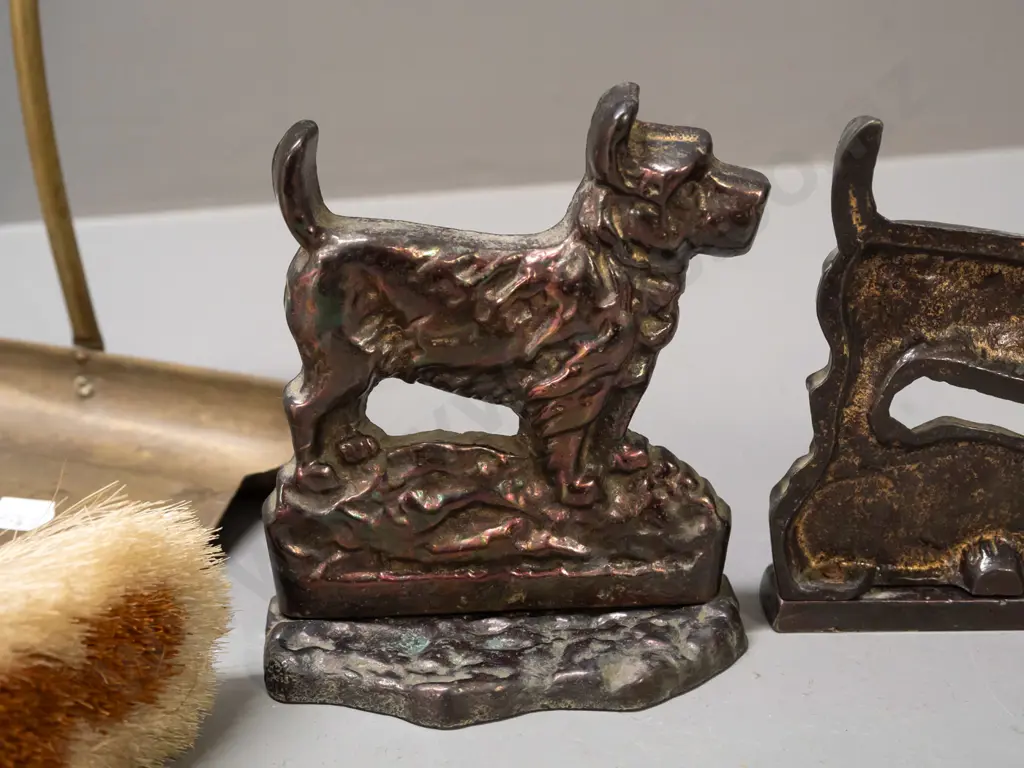 pair of cast metal Scottie dog book-ends with copper lustre finish and a crumb tray with hanging brush, may be missing Image 1++