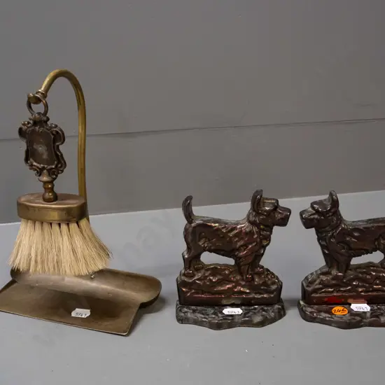 pair of cast metal Scottie dog book-ends with copper lustre finish and a crumb tray with hanging brush, may be missing