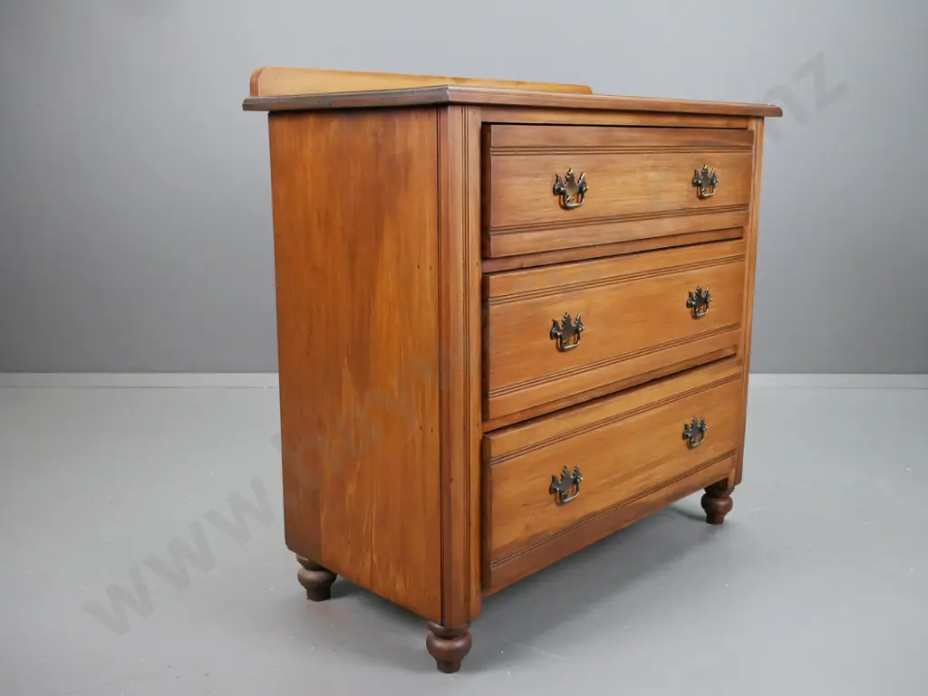 colonial rimu 3 drawer chest on turned bun feet with replacement brass handles, slight borer to top Image 1++