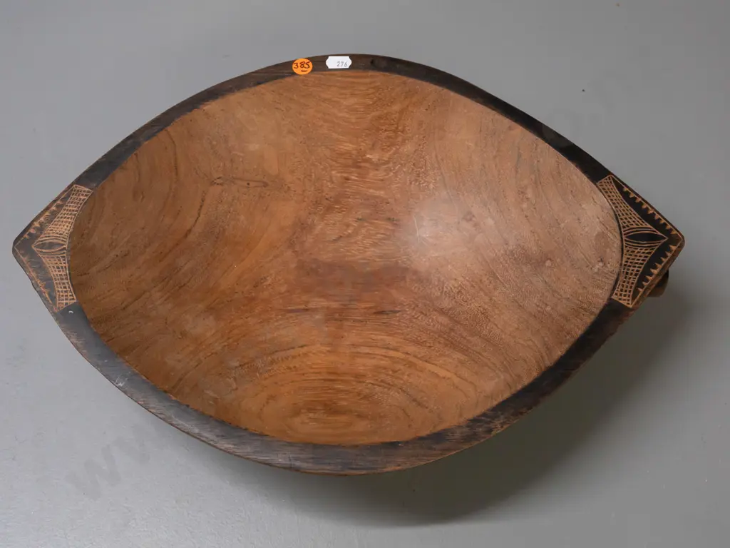 carved hardwood food bowl with bands of Pacific island style decoration, 4 feet, handles at ends - some discolouration Image 1++