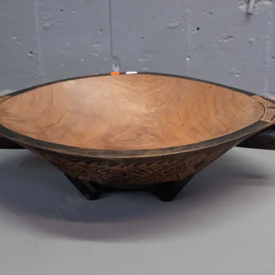carved hardwood food bowl with bands of Pacific island style decoration, 4 feet, handles at ends - some discolouration