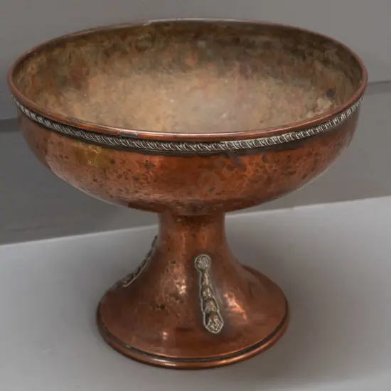 hand beaten copper comport with applied decoration on stem, remnant worn plating or lining to interior, has a few dents