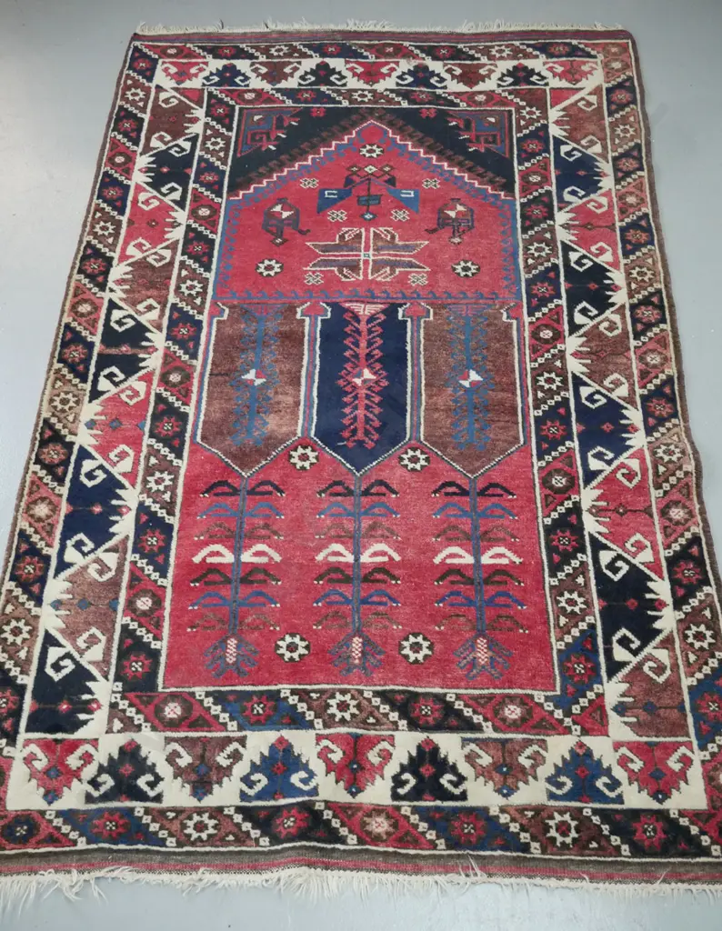 hand knotted woollen Persian style floor mat. Reds, ivories, blues. Geometric foliate decorations. Image 1++