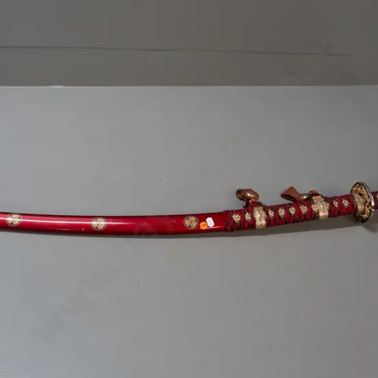 decorative reproduction Japanese sword w/ red and black cloth binding, gold and silver-colour alloy fittings, stainless