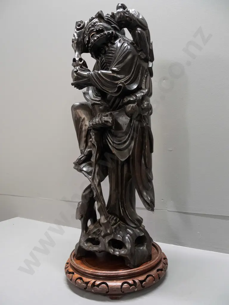 Chinese large carved hardwood figure of scholar with staff, one leg on tree roots, holding child, carved white teeth and Image 1++
