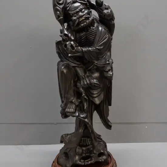 Chinese large carved hardwood figure of scholar with staff, one leg on tree roots, holding child, carved white teeth and