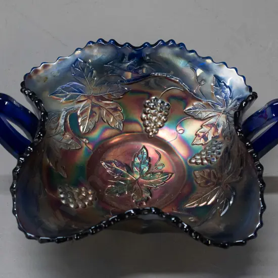 small cobalt blue carnival glass bowl - handled leaf shape, with grape leaf motifs H-80 W-180 across handles