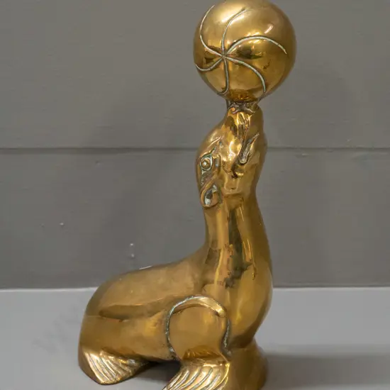 polished cast brass figure - seal balancing ball on nose H-230