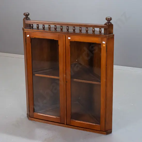 circa 1890s colonial kauri hanging glazed corner cupboard with turned top finials and gallery, one shelf inside, lock
