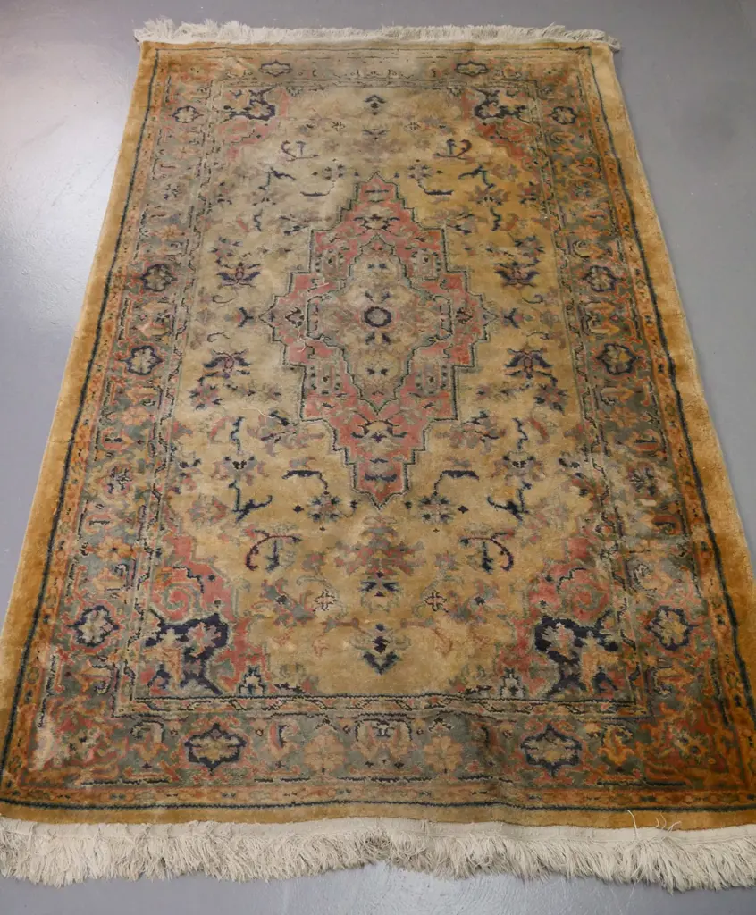 floor rug w/ geometric border & central motif in blues pinks & camel tones. Significant fading, some wear. W-1840 D-1170 Image 1++