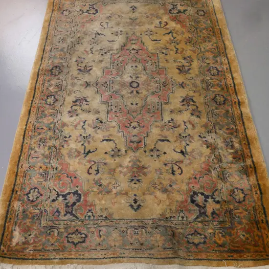 floor rug w/ geometric border & central motif in blues pinks & camel tones. Significant fading, some wear. W-1840 D-1170