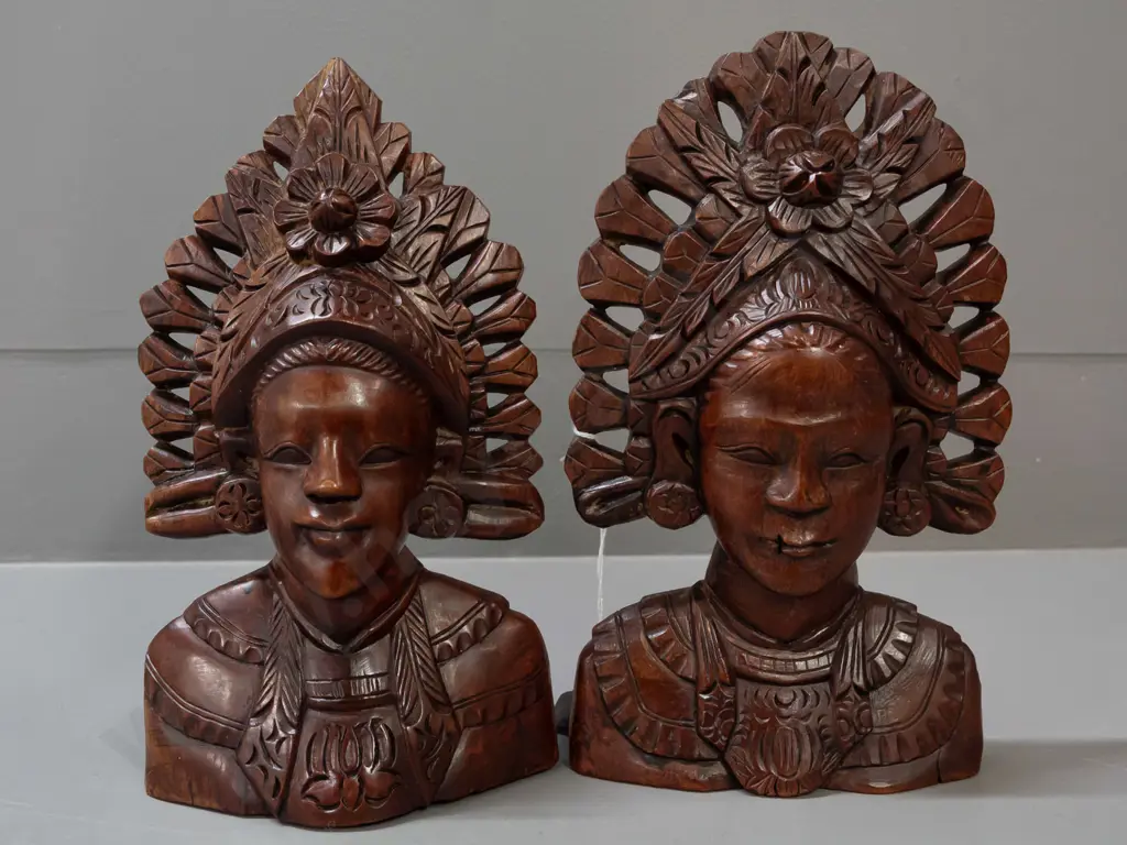 2 carved Indonesian hardwood busts with pierced edges - one with wall hanging eyelet in back - both with a few small Image 1++