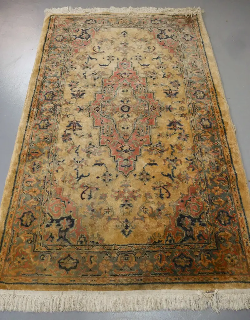 floor rug w/ geometric border & central motif in blues pinks & camel tones. Some wear to fringe & edging, some staining. Image 1++