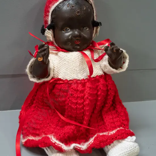 vintage doll with knit outfit, a few chipped fingers and peeling paint show brown fibre composite construction H-300