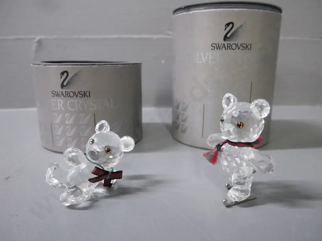 Swarovski 2x miniature teddy bear figurines, one skating, one lying down; w/ original packaging. H-50 Image 1++