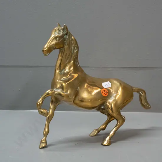 polished cast brass horse figure with one foot raised H-200 L-210