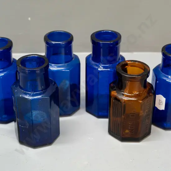 6 glass hexagonal faceted bottles, 4 cobalt blue and the amber bottle marked Strychine - Not to be Taken -