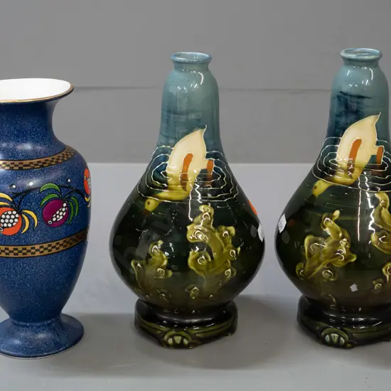 pair of Ravissant Ware vases with duck and pond motif and a Bisto England speckle blue and enamel fruit motif vase with