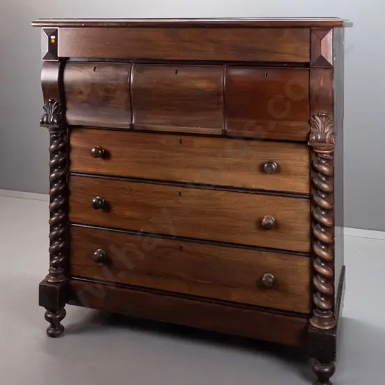 Victorian mahogany 7-drawer chest with 3 shaped top drawers, 3 with wooden knobs, turned half columns, on bun feet.