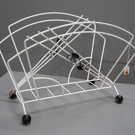 mid-century black and white metal magazine rack with applied wine leaves, black wooden ball feet - some paint loss to