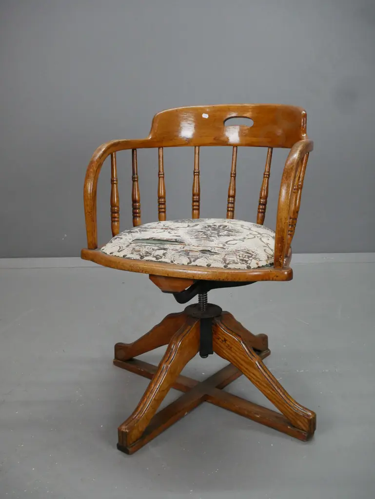vintage oak swivel office chair with turned back supports, upholstered seat. 4 sweeping legs to X frame Image 1++