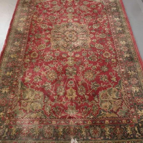 Persian style wool floor rug in red, green & gold - repairs, wear and dye run in fringe, some overall staining 2060x1250
