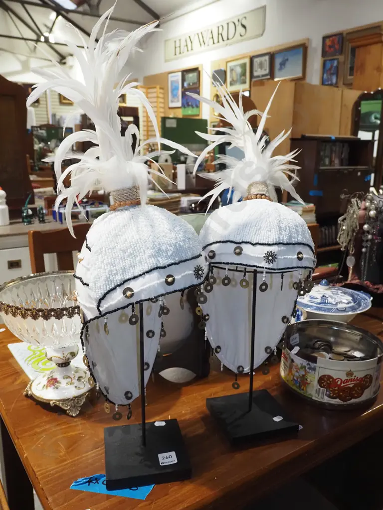 pair of feathered showgirl hats on stands Image 1++