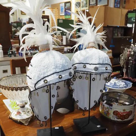 pair of feathered showgirl hats on stands