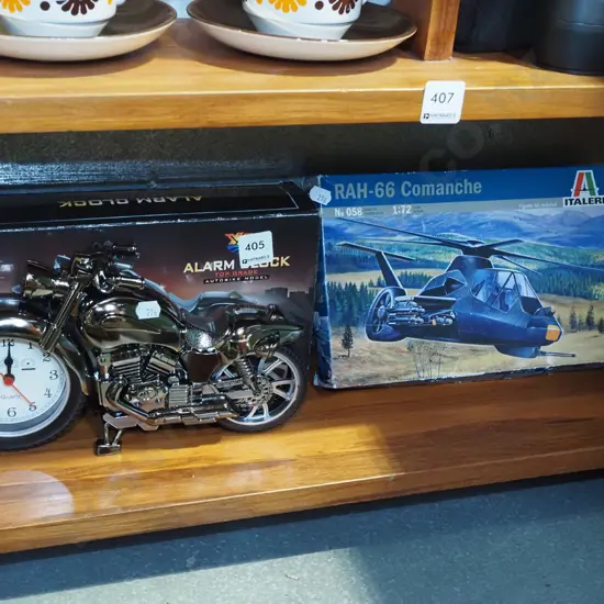 yet to be assembled scale model of comanche helicopter, motorcycle alarm clock