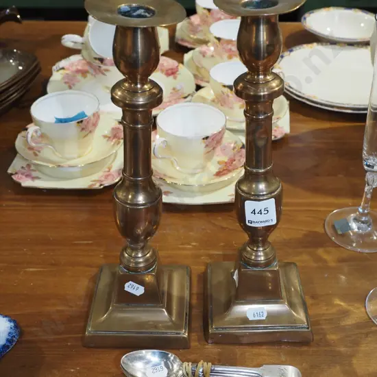 2x brass candlesticks - 1 on lean, both with dents H-290, plated teaspoons