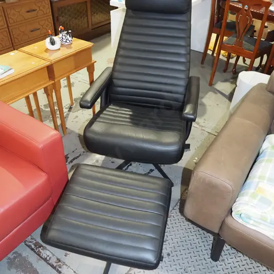 black vinyl upholstered swivel reclining armchair with matching footstool