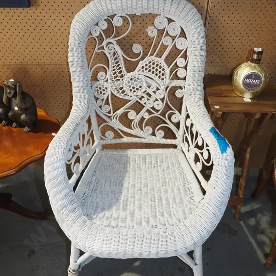 woven cane armchair with peacock design