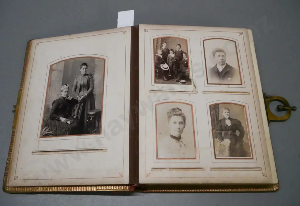 Leather-bound photo album w/ metal clasp, corners & crest. 13 pages of photographs, mechanical music box mechanism. Image 1++