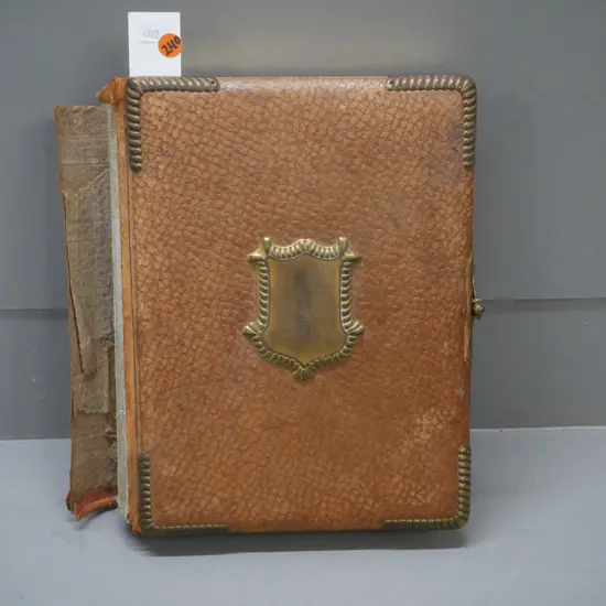 Leather-bound photo album w/ metal clasp, corners & crest. 13 pages of photographs, mechanical music box mechanism.