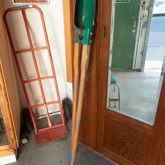wood-handled post hole digger