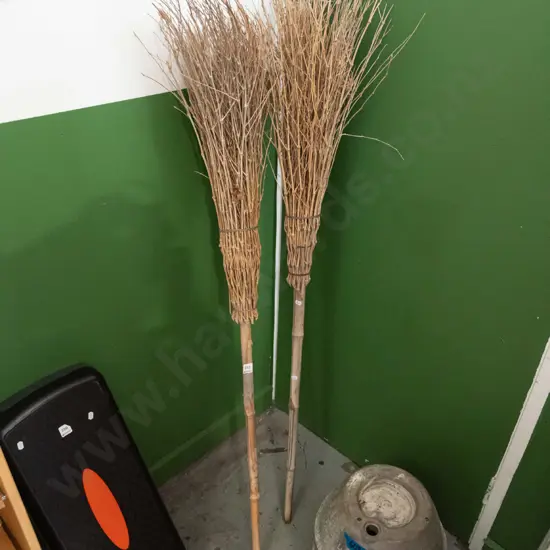 pair of bamboo and brush brooms
