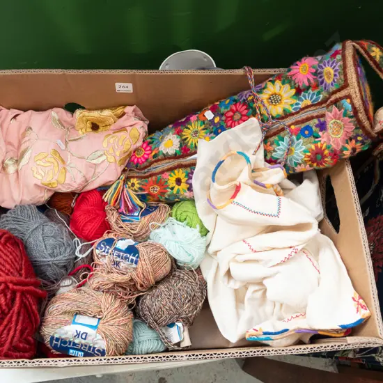 box; knitting yarns, needles, hand worked dress etc