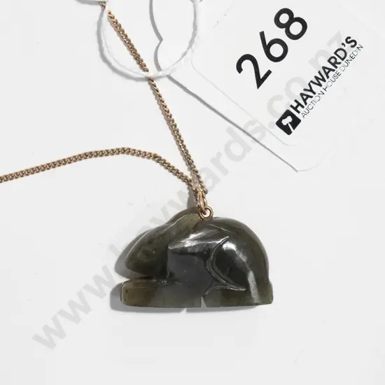 gold coloured chain with greenstone pendant