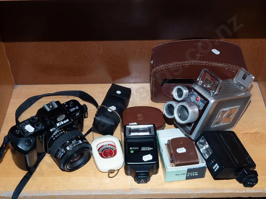 box; Nikon F-401 35mm camera, flashes and accessories, Brownie movie camera Image 1++