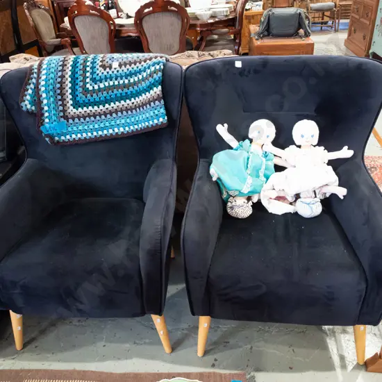 pair of black upholstered modern armchairs