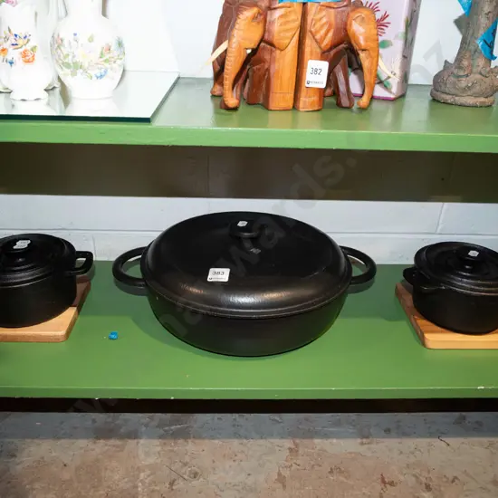 2x small cast iron casseroles on wooden stand, 1 other cast iron casserole Diam300