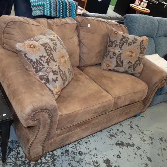 brown suedette rolled arm 2 seater settee, 2 matching floral cushions