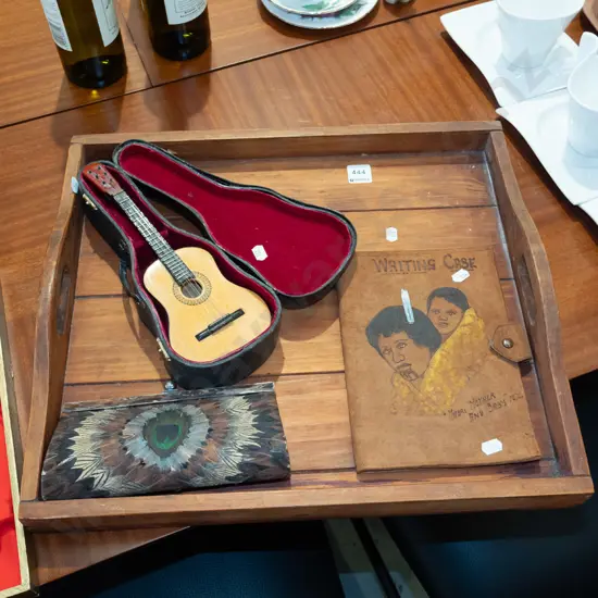 wooden tray; peacock feather decorated purse, tiny guitar, tooled leather Maori themed writing case