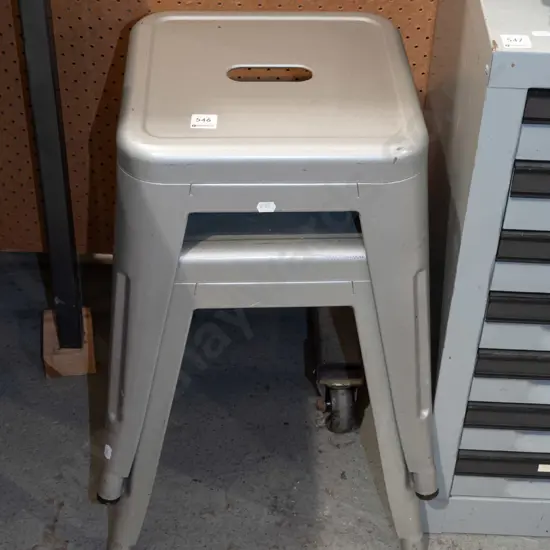 pair of small grey metal stools