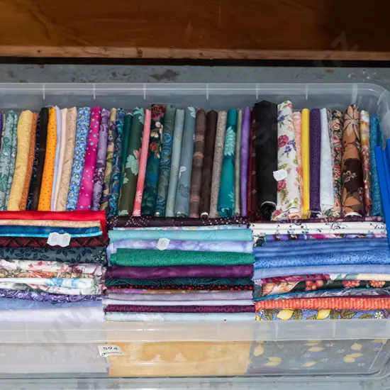 plastic tub of fabric pieces