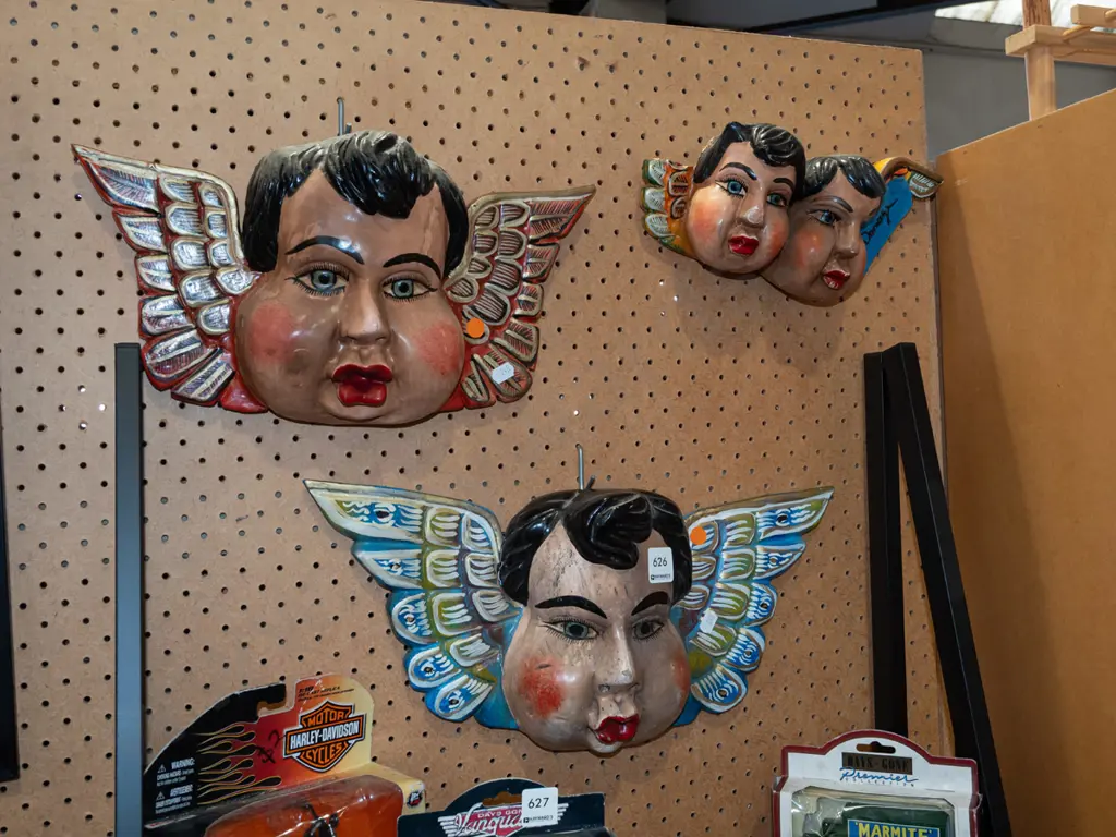 3x hand painted carved faces with wings - 1 has damage to 1 wing Image 1++