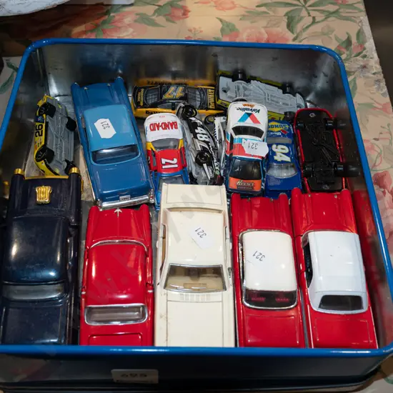 tin of toy vehicles