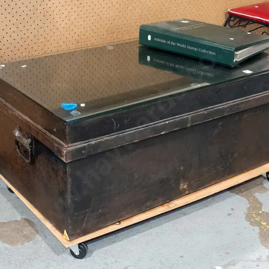 tin travellers trunk on casters with glass top to create coffee table