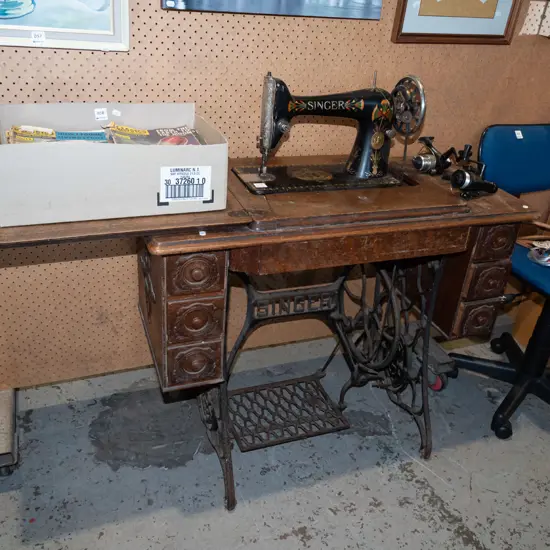 restorer's Singer treadle sewing machine with original belt - signs of age and wear