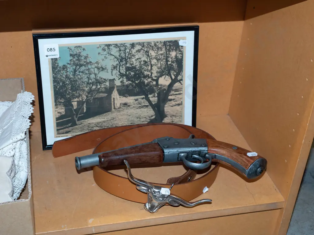 reproduction pistol, belt with long horn buckle, framed newspaper picture  Image 1++